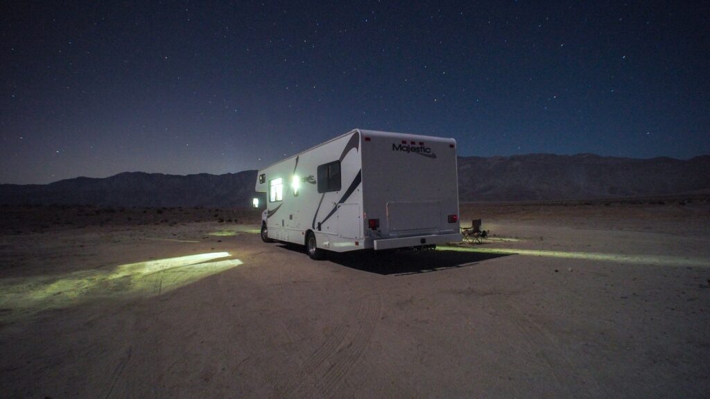 RV parked at night under a starry sky