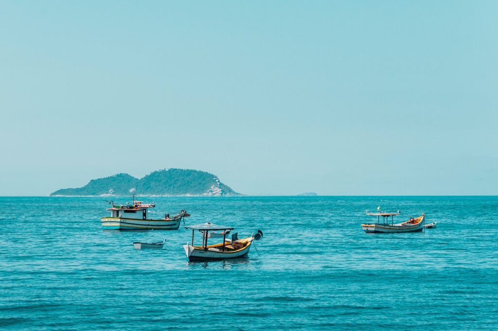 three boats on the ocean