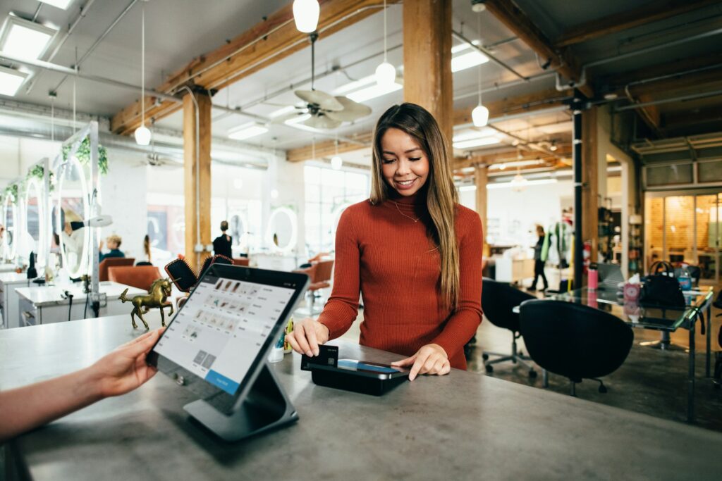 Woman paying by card at a checkout