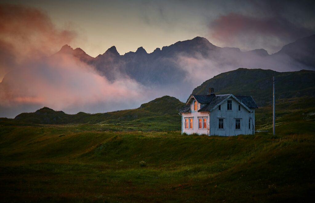 Grey house on a green hill