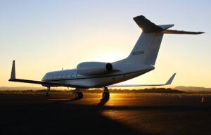 Private jet on a runway at sunset