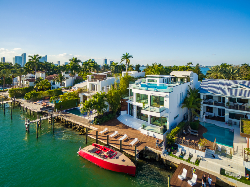 White villas on the water with a red boat in Miami