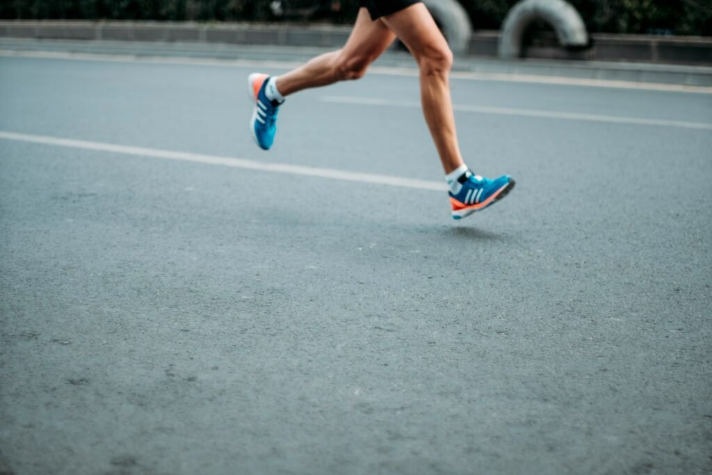 Runner's legs with blue and pink sneakers
